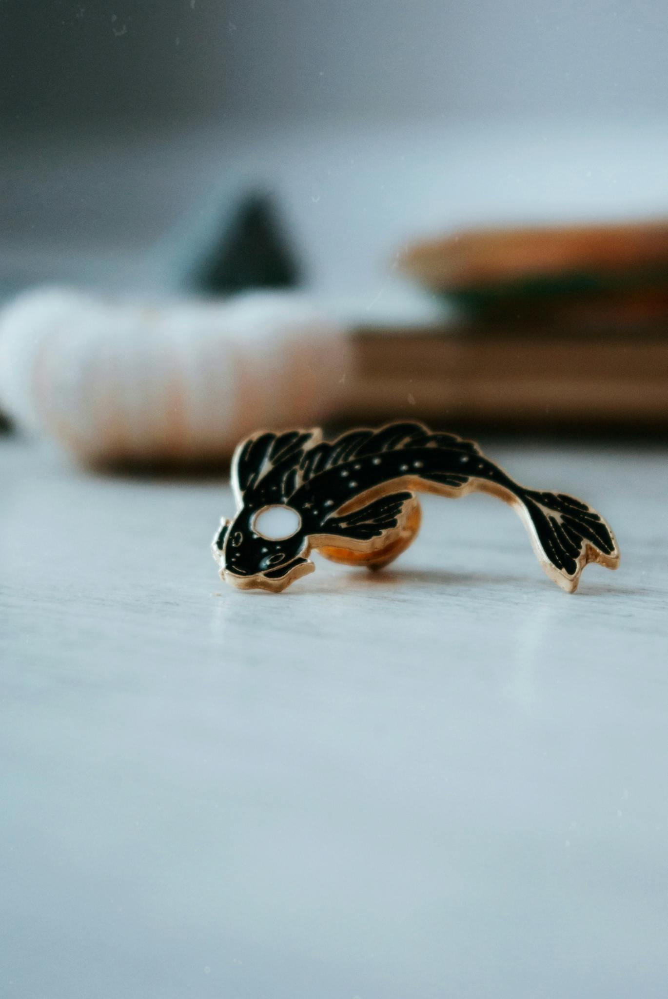 Artistic close-up of a fish-shaped accessory placed on a table, offering a unique perspective.